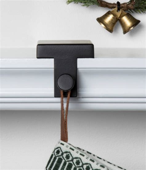 When hung on a twinkly, battery-operated Christmas stocking holder, stockings with 3D antlers, ears, and pom-poms look whimsical. Show your pup some holiday cheer with a gold-toned metal dog bone stocking holder with a marble base, or hang your favorite stocking on a mantle clip, peg, or hook for a classic look.